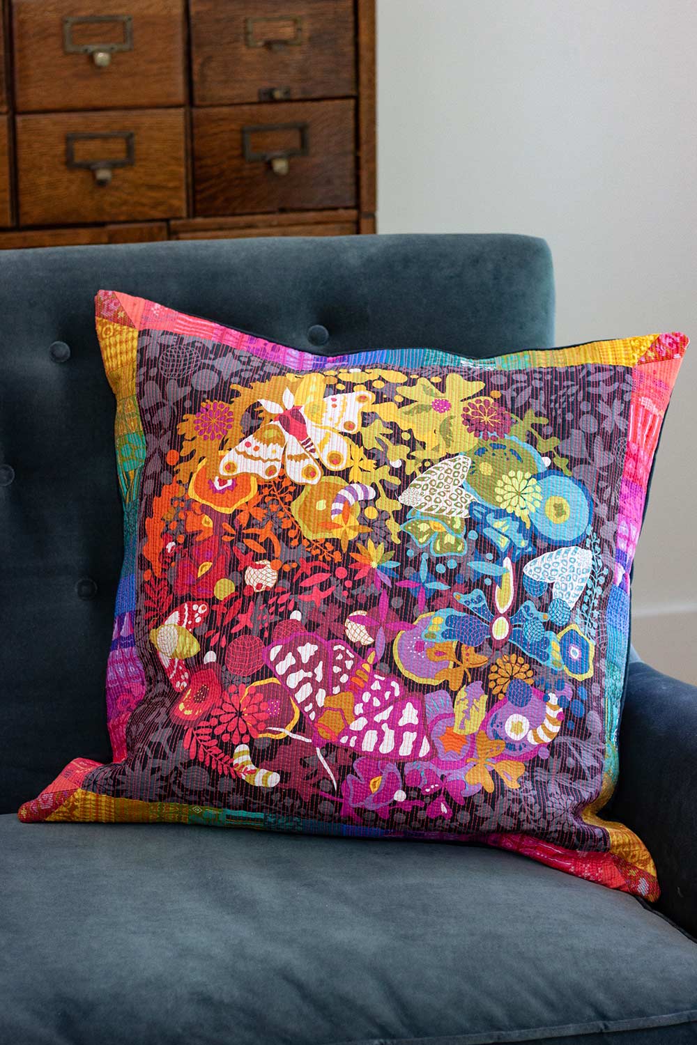 art theory pillow with neon peach quilting