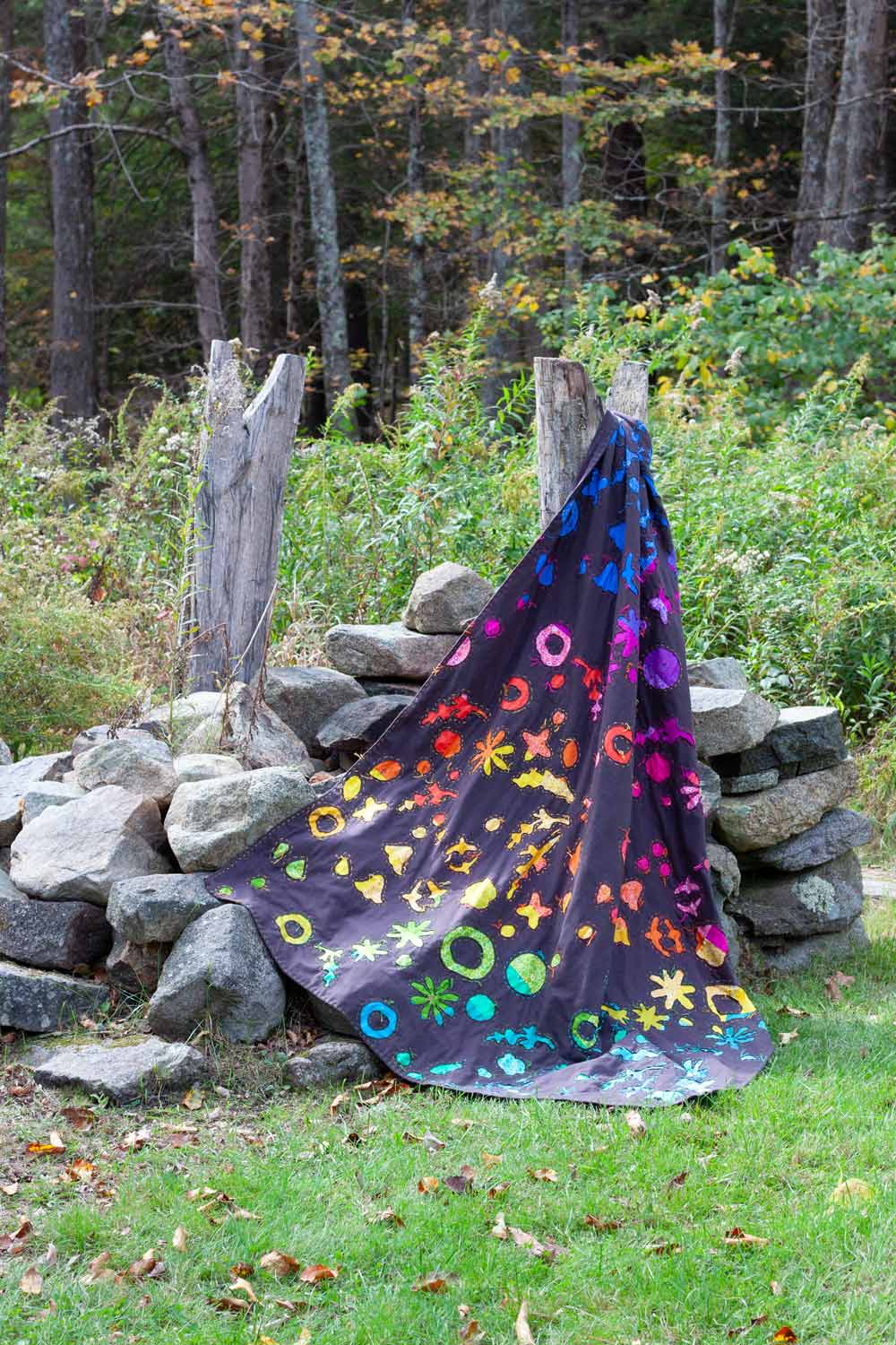 cozy scattered petal rainbow quilt