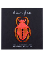 pink neon scarab patch