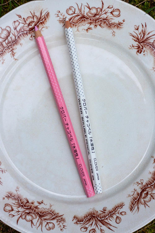 white and pink marking pencils